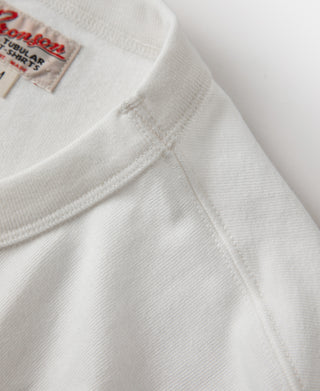 White crewneck tubular athletic t-shirt with stitched collar seam and logo label.