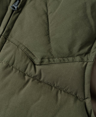 Olive quilted padded vest panel seams with V-shaped stitching detail