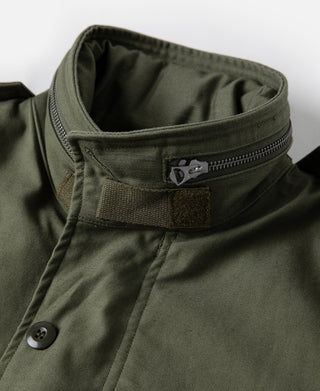 Olive field jacket neck with zipper, button, and woven brand patch