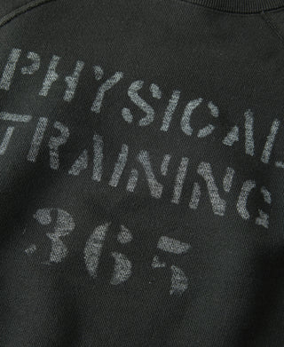 Vintage black sweater close-up of “Physical Training” lettering on chest