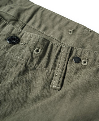 Olive fabric utility pants detail with buttons and woven texture