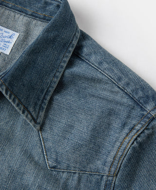 Blue slub denim western shirt close-up of collar seam and topstitching.