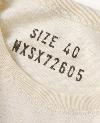 Close-up of light apricot ribbed collar with printed size and number markings