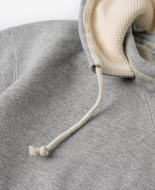 Gray terry hood seam detail with cream drawstring and stitched edge