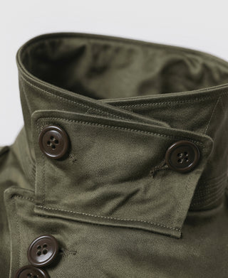Olive field jacket collar and button placket detail with flap construction