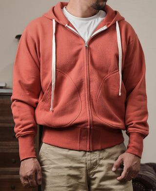 Brick red terry cloth full-zip hoodie, hood with white drawstrings and front zipper
