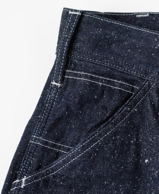 Indigo denim carpenter pocket with diagonal stitching and bar-tack reinforcement