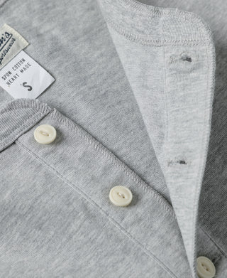 Gray cotton henley with short sleeve cuff and three-button front detail