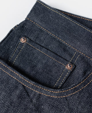 Indigo denim jeans back yoke with copper-tone stitching and rivet details