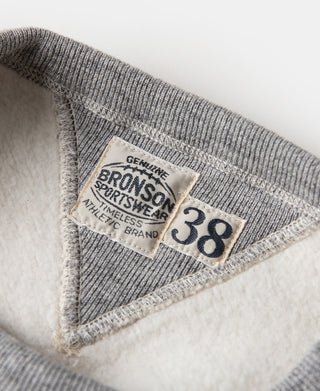 Gray sweater inside neck label with size 38 and “BRONSON BR...FR” text