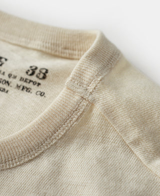 Cream T-shirt shoulder seam and neckline rib trim close-up