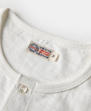 White henley t-shirt neckline detail with embroidered brand label inside