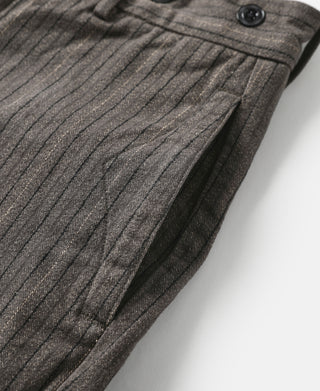 Dark gray pinstripe pants close-up of pleated leg and curved hem seam