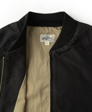 Black bomber jacket lining in tan with brand label at neck
