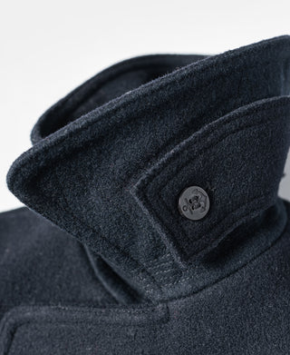 Navy peacoat close-up of folded collar and metal button