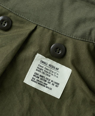 Olive field jacket interior label near button closure