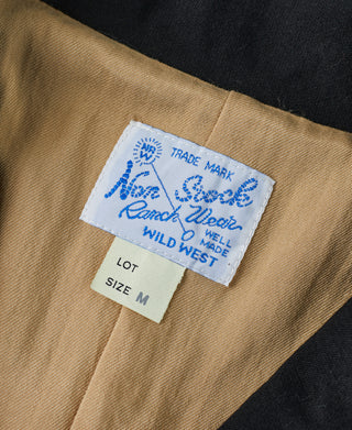 Black jacket interior label: brand Trade Mark, size M, Wild West label patch