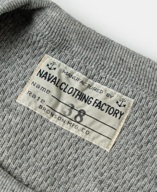 Gray waffle thermal shirt label patch on knit collar, text and logo visible