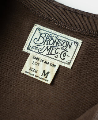 Coffee-brown henley shirt brand label and size M tag near neck collar