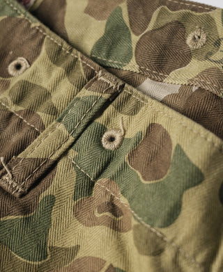 Camouflage cotton waistband seam with stitched button placket and textured herringbone weave
