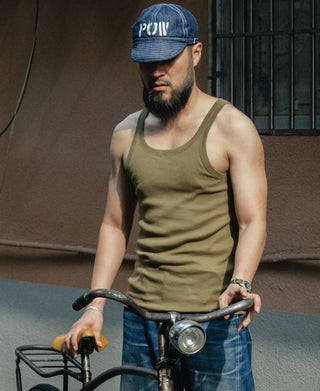 Olive crew-neck cotton tank top on model, sleeveless cut