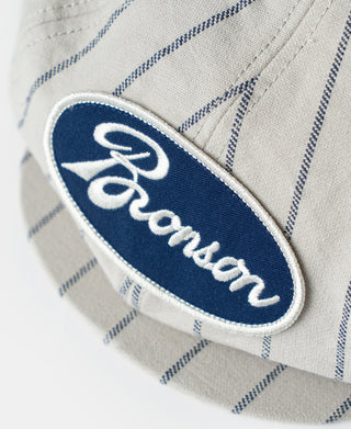 Bronson logo patch on gray railroad stripe newsboy cap