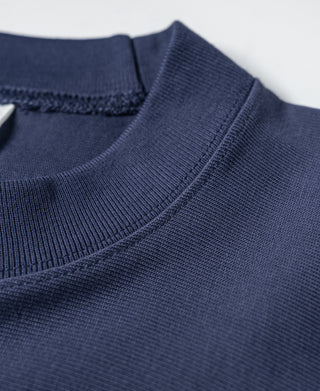 Navy T-shirt neckline seam detail with ribbed collar and stitched shoulder