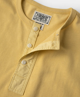 Yellow henley T-shirt with white buttons and stitched placket