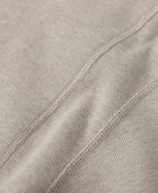 Close-up of light heather beige undershirt seam and ribbed knit texture