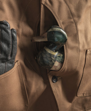 Khaki canvas hunting vest detail with chest button and inner pocket