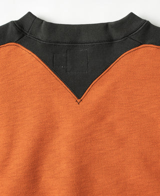 Orange sweatshirt front with dark V-inset neckline and ribbed black collar.