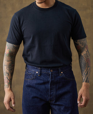 Dark crew-neck cotton T-shirt on model, short sleeves and straight hem fit