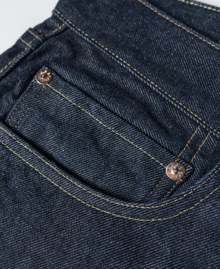 Indigo denim jeans front pockets with copper-tone buttons and stitched seams