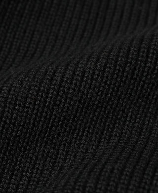 Black wool sweater knit texture close-up with ribbed pattern detail