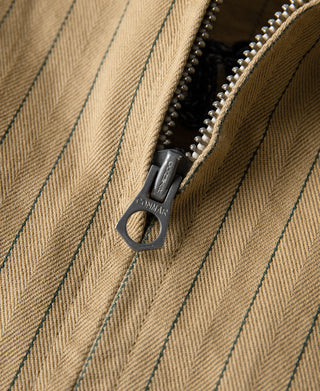 Khaki striped chore coat zipper pull with metal ring and textured weave