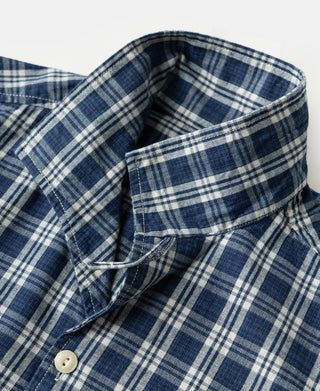 Blue plaid camp collar with fabric lining and off-white button at front