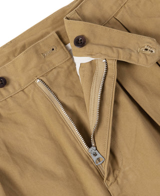 Tan chino trousers with zippered fly, two buttons, and belt loop hardware
