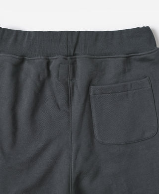 Black terry sweatpants close-up, drawstring seam and front patch pocket