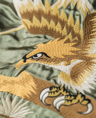 Embroidered falcon on olive green reversible jacket with gold and white thread details.