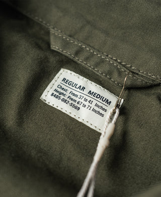 Olive jacket size label reading "REGULAR MEDIUM" inside neckline