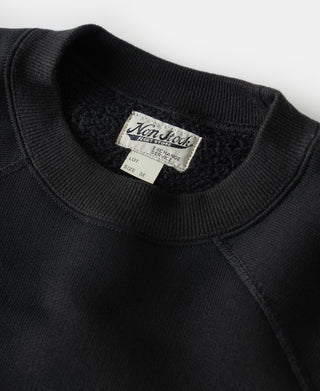 Black raglan sweatshirt neck label and ribbed collar detail