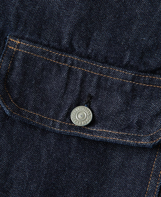 Round metal snap on indigo denim jacket flap pocket with contrast topstitching