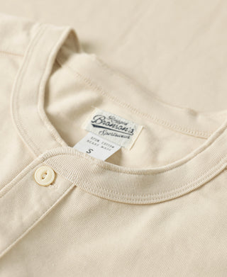 Apricot henley T-shirt neckline with three buttons and interior neck label