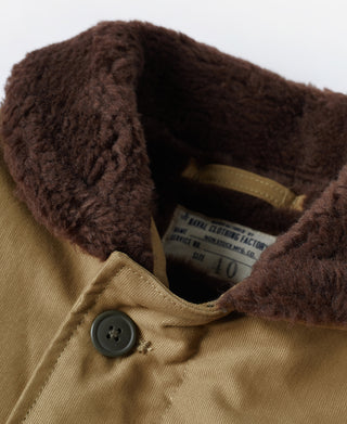 Khaki deck jacket collar close-up with brown sherpa lining and button detail