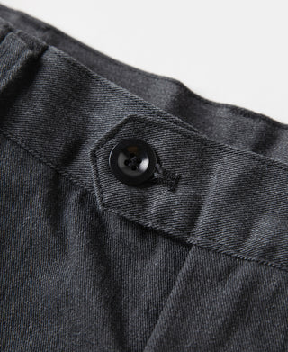 Dark gray pleated chino trousers with dark button and tailored waistband seam