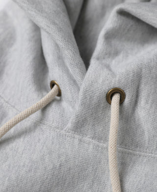 Gray hoodie drawcord eyelets and metal aglets, close-up