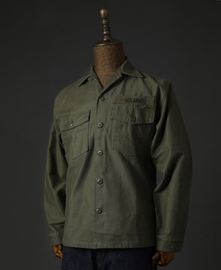 Olive fatigue utility shirt on mannequin, chest pockets and button front