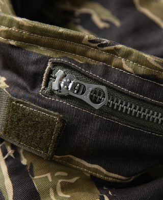 Camouflage jacket zipper pull and zipper teeth with stitched pocket seam