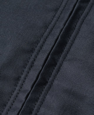 Navy deck jacket fabric close-up with stitched seam lines