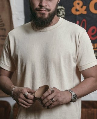 Apricot crew-neck athletic T-shirt, close view of chest and neckline seam.